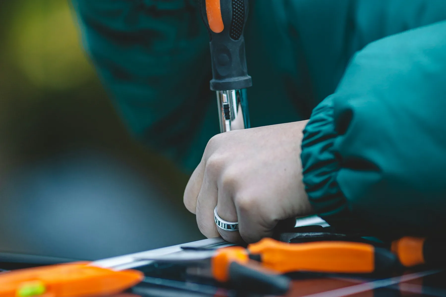 Technician using a hand tool during an industrial assembly task