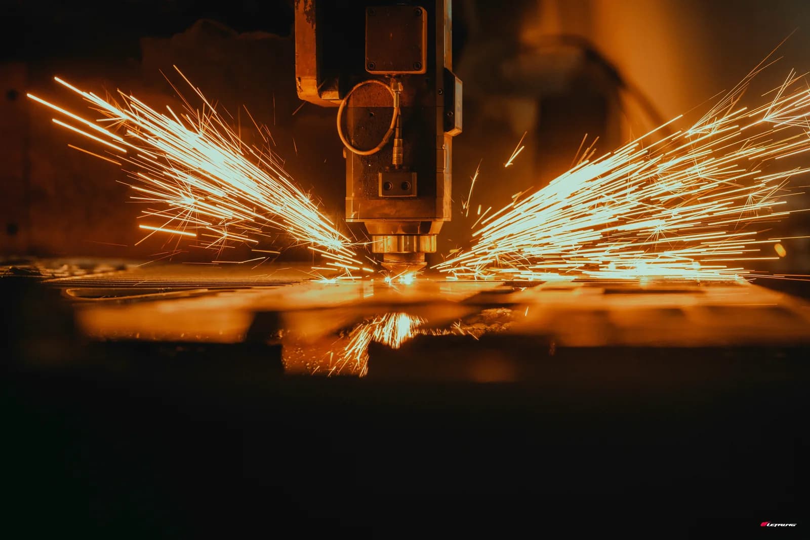 Laser cutting machine producing metal parts on an industrial line